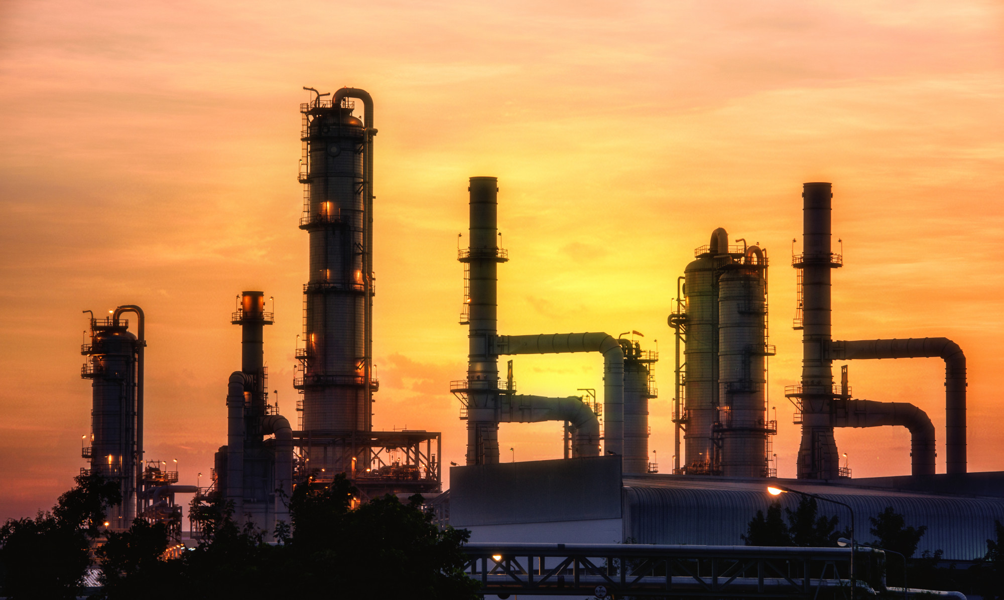 Oil and gas refinery at sunset